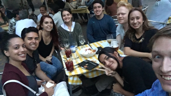 Jordan and friends sitting around a small table at a busy restaurant